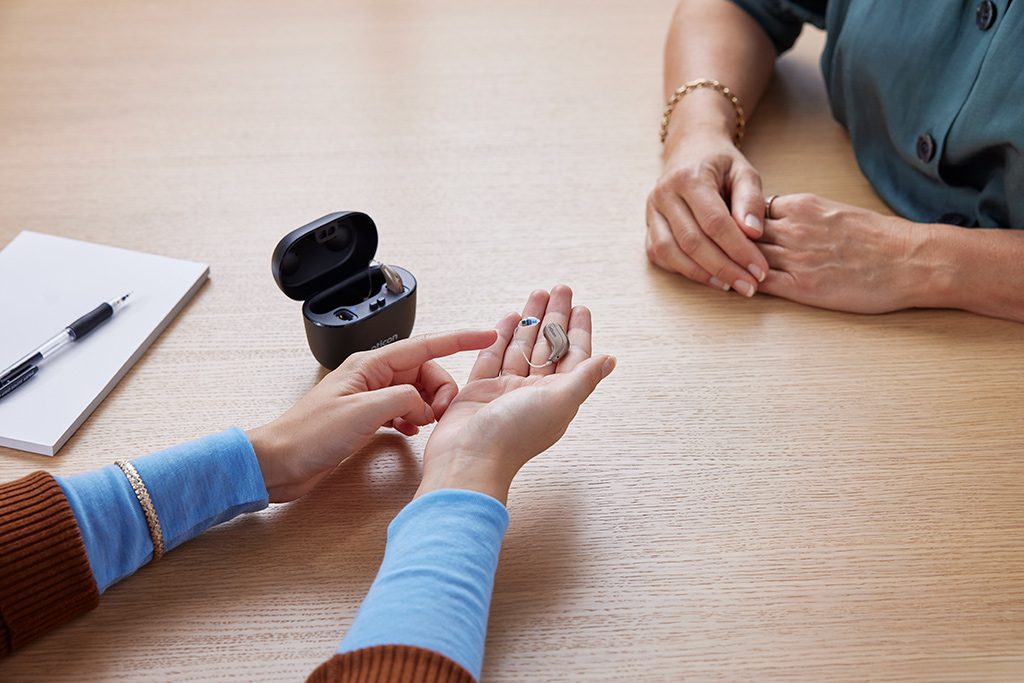 Oticon Intent hearing aids with SmartCharger during a fitting consultation